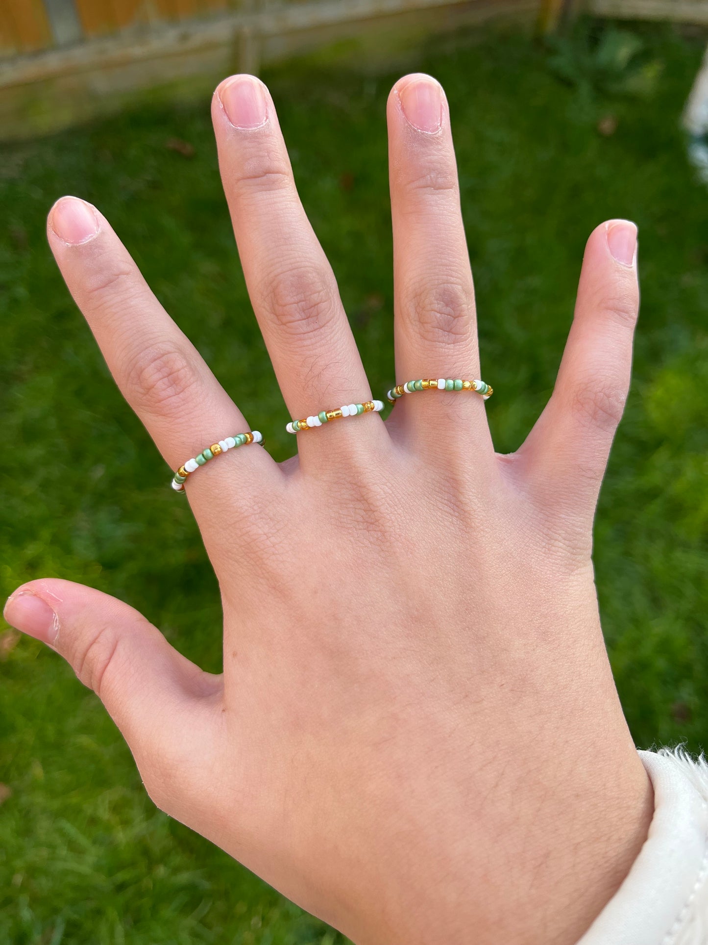 White, gold and green beaded ring set