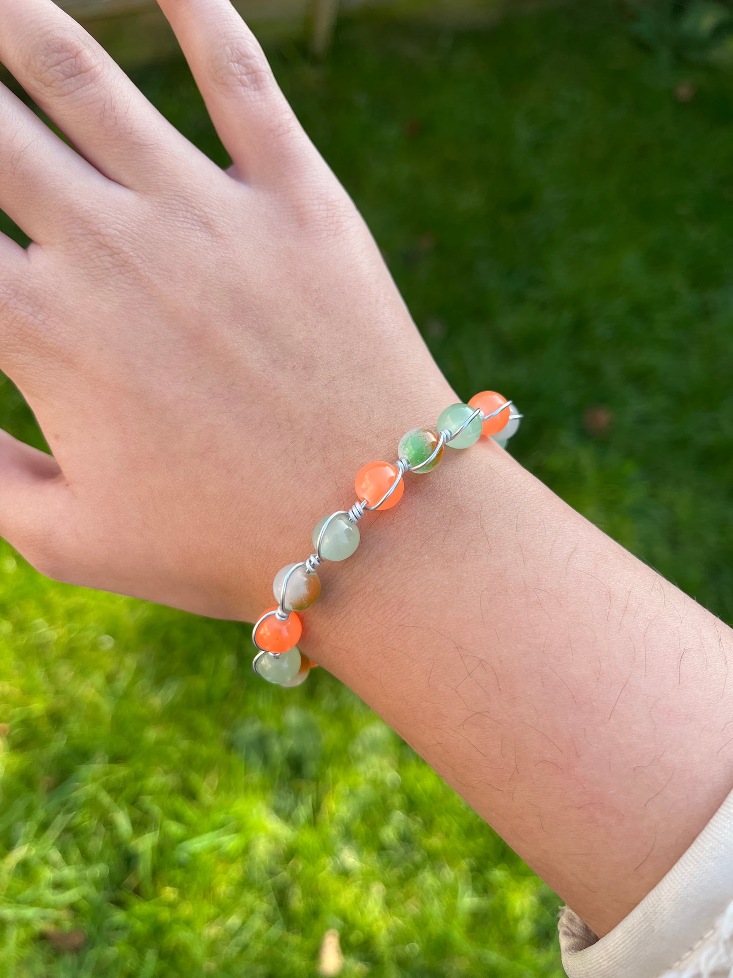 Orange and green wire wrapped bracelet