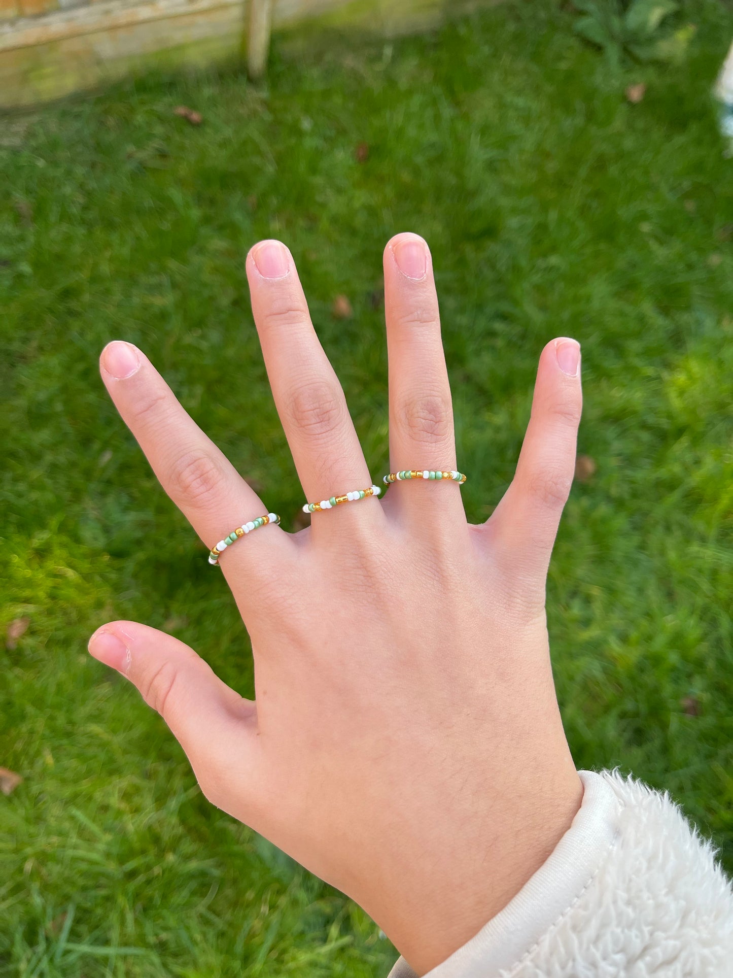 White, gold and green beaded ring set