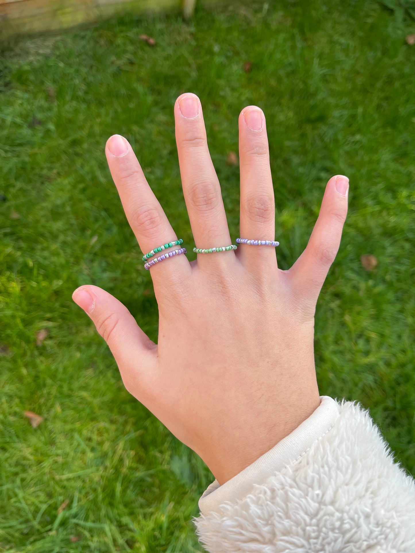 Purple and green beaded ring set