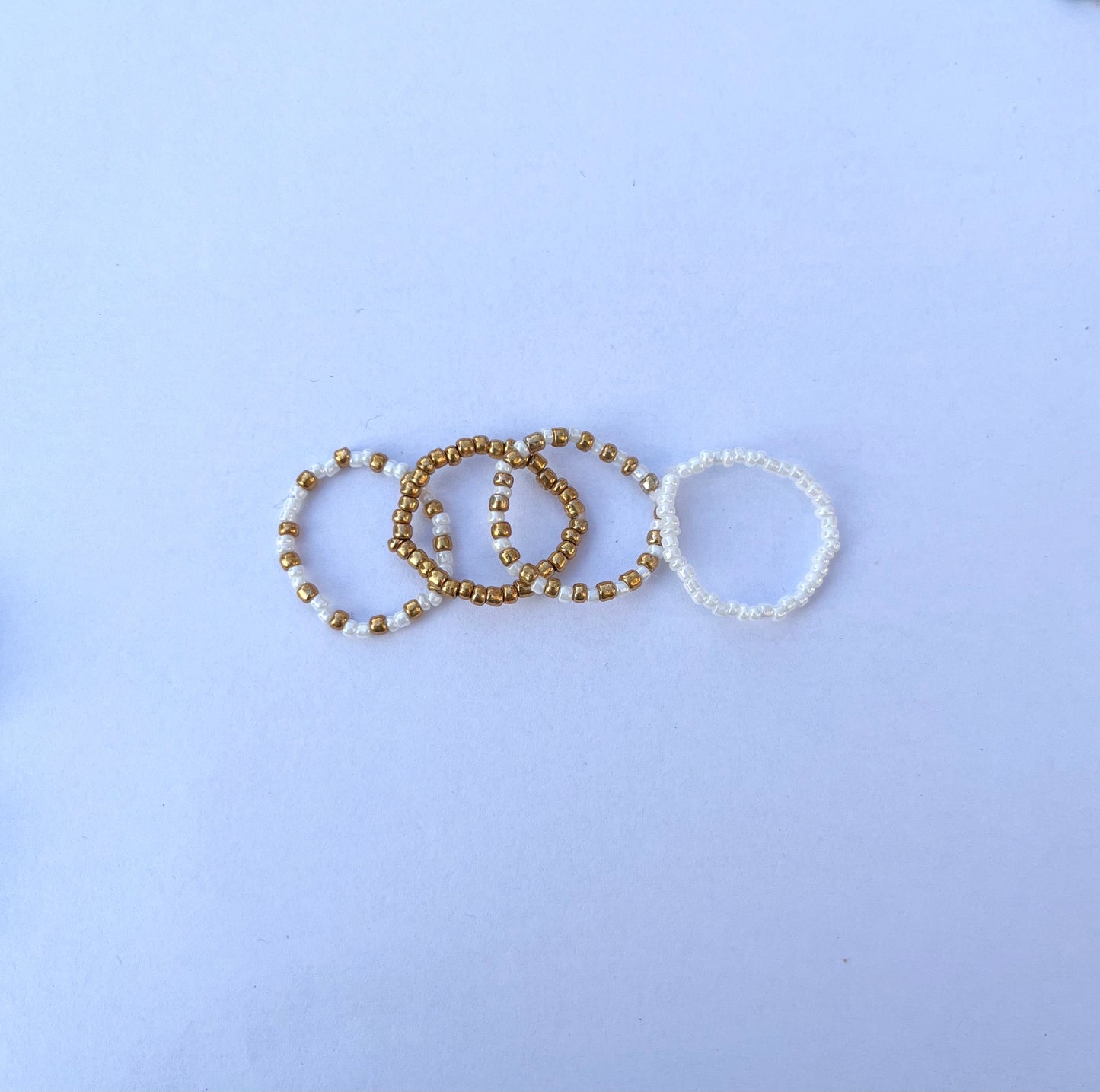 White and gold beaded ring set