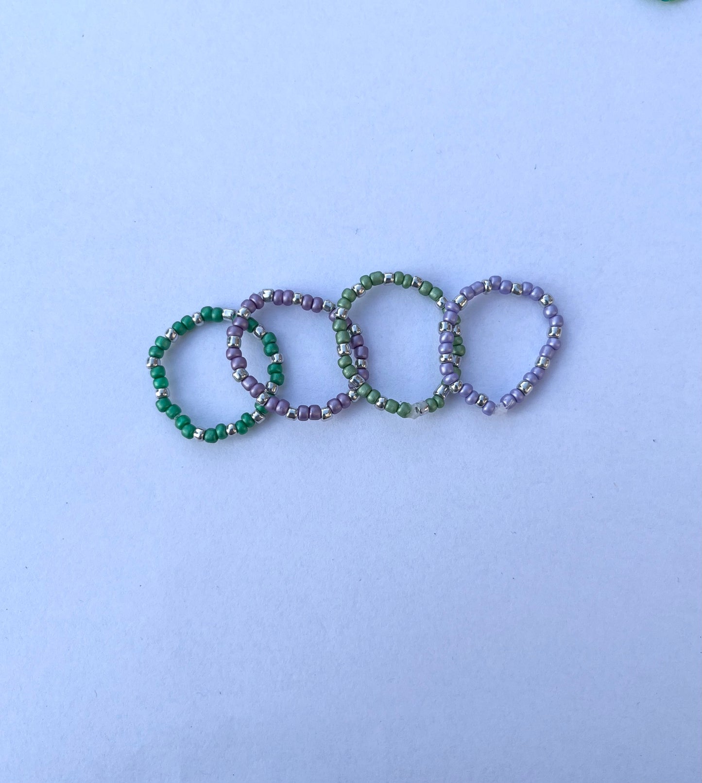 Purple and green beaded ring set