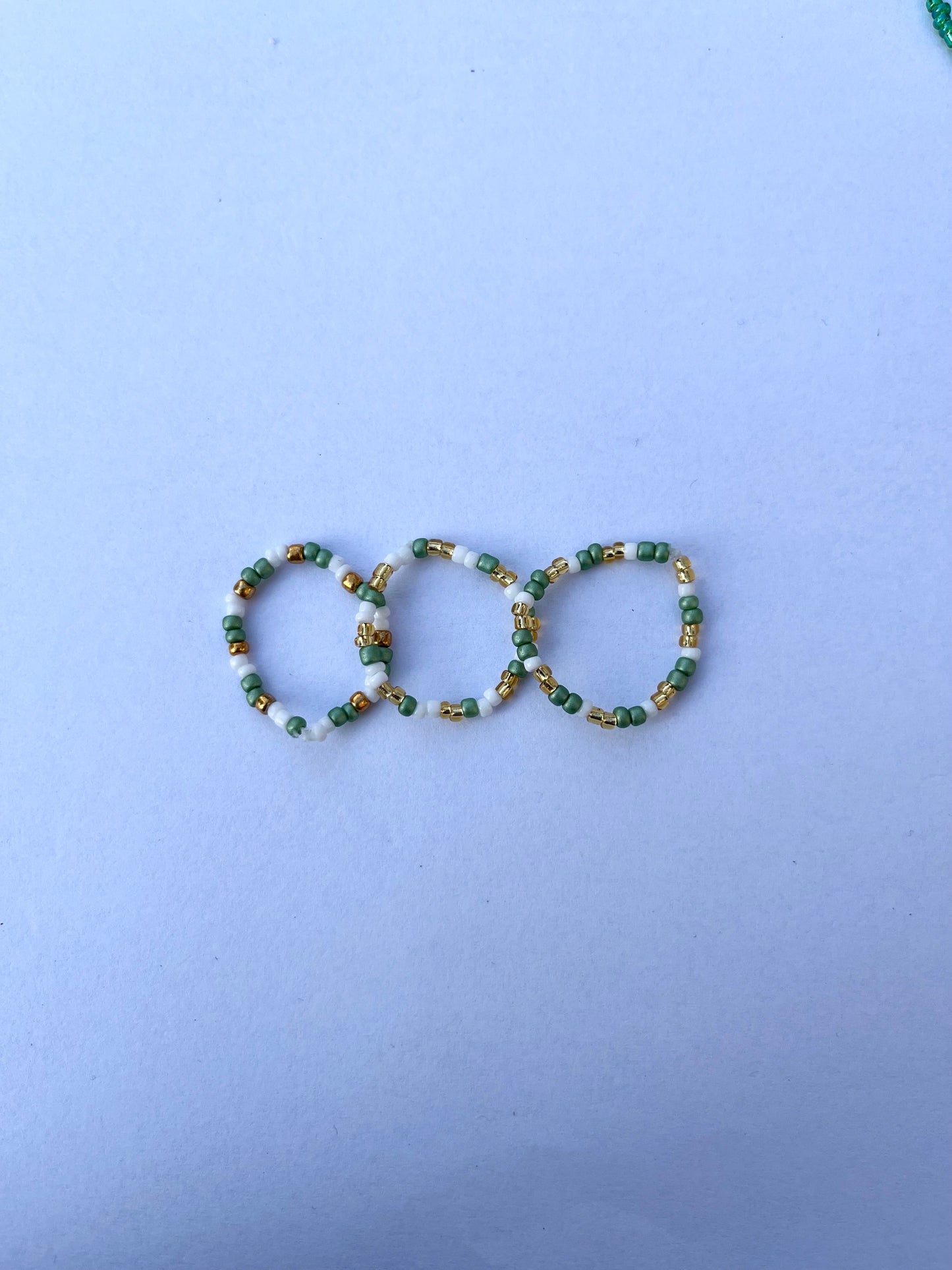 White, gold and green beaded ring set